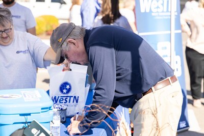 An attendee signs up for a giveaway during the celebration.