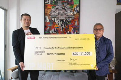 POP MART's Kevin Zhang (left) presents a donation to Michael Tay, Founder of The Foundation for The Arts and Social Enterprise (right), supporting the UTOPIA Reimagined initiative in Singapore.