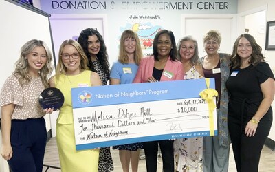 Nation of Neighbors recipient Melissa Dohme Hill receiving her award and grant with Royal Neighbors CEO Zarifa Reynolds and staff.