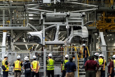 Hyundai Motor Group Metaplant America employees watch as a pre-production IONIQ 9 makes its way through General Assembly in Ellabell, GA in November 2024.