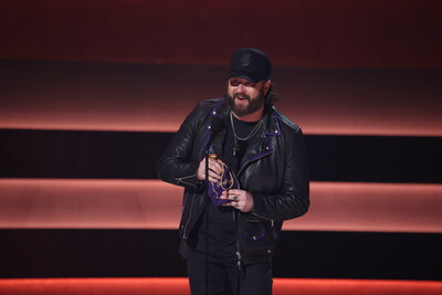 Nate Smith on stage at “The 58th Annual CMA Awards,” presents donation of <money>$50,000</money>, to CreatiVets on behalf of Crown Royal.