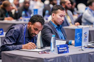 The trainees take notes during the lecture.