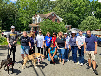 GOING PLACES: Volunteers from MainStreet Bank in Fairfax, Virginia, get ready to take adoptable dogs for a walk at Homeward Trails Animal Rescue in nearby Fairfax Station. The community bank offers employee benefits that encourage volunteerism and employee-directed giving.