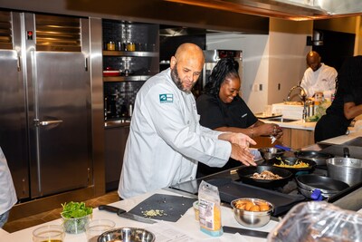 Chef Joseph DeJarnette learning new cooking techniques in a Restaurant Ready Training session with Chef Krisha and Chef Duane Brown.