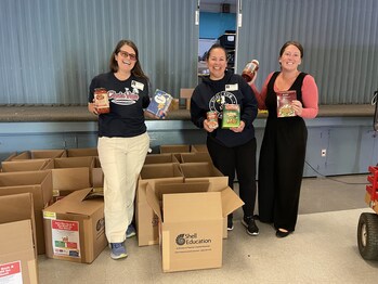 PTA members display pasta and sauce donations collected for the cause