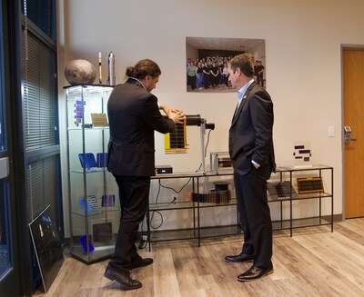 From left: Solestial CEO and Co-Founder, Stan Herasimenka, shows Rep. Greg Stanton a flexible solar power module that can be integrated with roll-out solar array deployment systems in space.