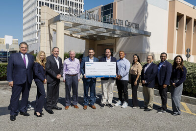 (left to right) Brandon Ramirez, director, corporate social responsibility, Hyundai Motor North America (center right) presents a check to Dr. José Mayorga, executive medical director, UCI Health Family Health Center (center left), and UCI FQHC executive council members, and Thea Nguyen, corporate social responsibility, Hyundai Motor North America, at UCI Health Family Health Center in Santa Ana, Calif. on Oct. 9, 2024 (Photo/Hyundai)