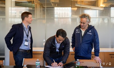 Ryan Tseng, Shield AI's CEO, signs strategic partnership deal while Ryan Taylor, Palantir's Chief Revenue and Chief Legal Officer (left) and Dr. Alex Karp, Palantir's Co-Founder and CEO (right) look on.