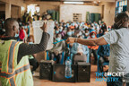 Local missionaries with The Bucket Ministry demonstrate the effectiveness of the filter at a distribution event in the Kibera slum.