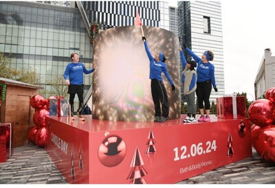 Gold medalist athletes Hunter Woodhall, Tara Davis-Woodhall and Jordan Chiles ceremoniously light a giant Bath & Body Works candle in New York City’s Hudson Yards to help kick off the brand’s annual Candle Day.