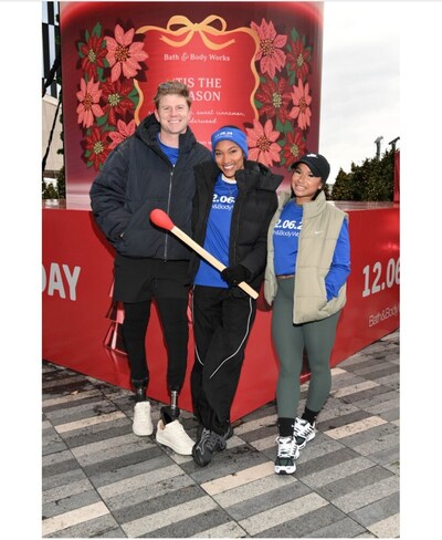 American gold medalists Hunter Woodhall, Tara Davis-Woodhall and Jordan Chiles pose in front of Bath & Body Works’ giant 12-foot candle in Hudson Yards.