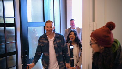 Josh and Melanie Sager sharing a joyful moment as they enter their new home.