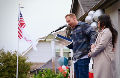 Army veteran Josh Sager addresses crowd from the porch of his new home during the 400th Building Homes for Heroes home milestone ceremony.