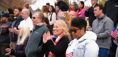 Local Argyle, TX community members showing support during the home ceremony, with attendees holding American flags.