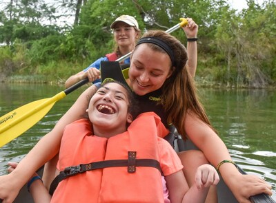 camper with volunteers, canoeing at CAMP on the Guadalupe River