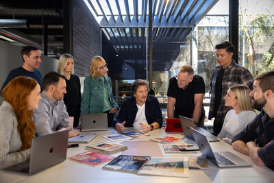 Manley Creative team gathers for client review in new office.