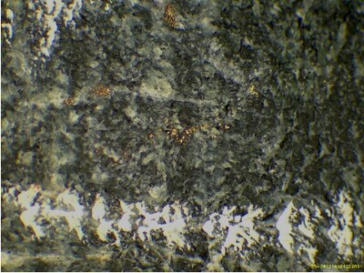 Photo 9: Microscopic view of mineralization in hole WD24-35. (CNW Group/Omineca Mining and Metals Ltd.)