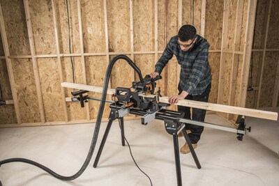 R185SMS+ sliding mitre saw on Evolution Power Tools mitre stand, attached to a vacuum for dust extraction.