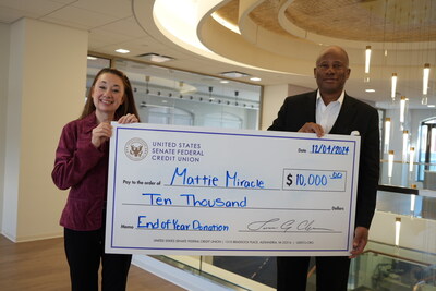 USSFCU President and CEO Tim Anderson presents donation to Mattie Miracle Cancer Foundation: $10,000 to assist children and families impacted by childhood cancer.