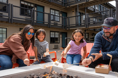 Wave Street Inn patio with family enjoying smores