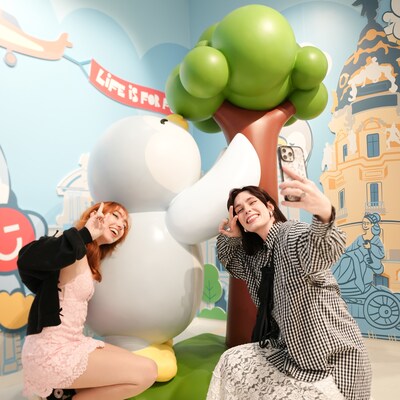 Customers taking photos with the Penpen Madrid tree-hugging design