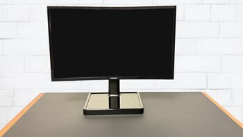 The Wire-Free Power Minimalist Desk, a collaboration between Powercast and Etherdyne, demonstrates how magnetic resonance technology can provide up to 100 Watts of power to wirelessly power multiple desktop devices over the air, such as a computer monitor (pictured here), laptop charging stand, desk lamp, and Qi-compatible phone charger.