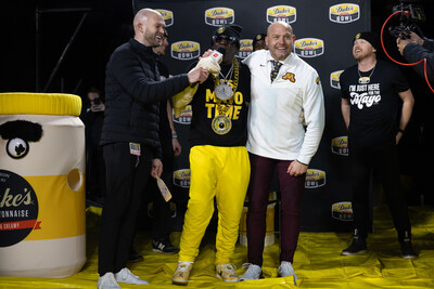 Flavor Flav is interviewed with Minnesota Coach P.J. Fleck after he's revealed as Duke's Mayo's mystery mascot.