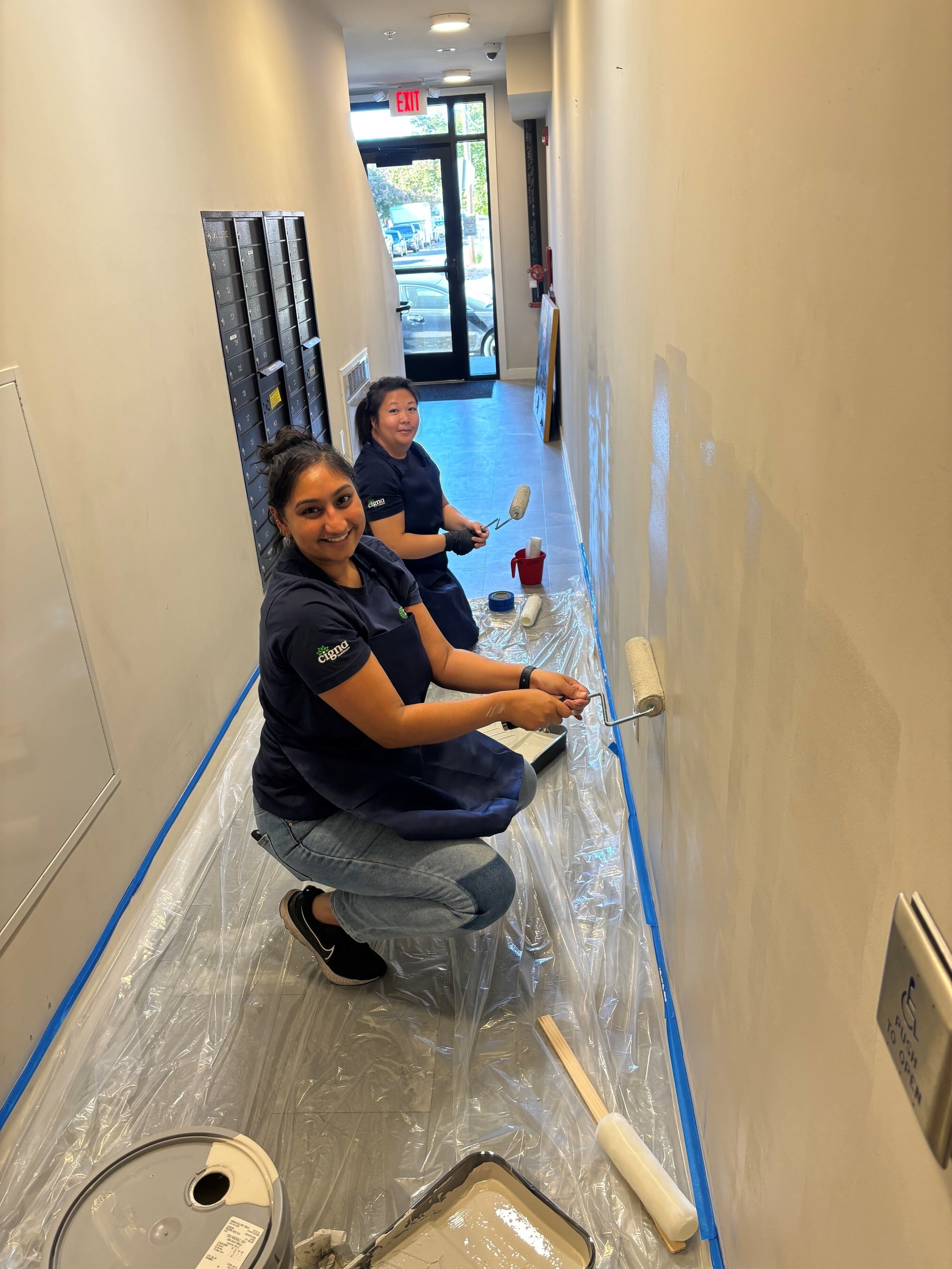 Volunteers from The Cigna Group paint and refresh common areas with Veterans Village in Philadelphia, PA.