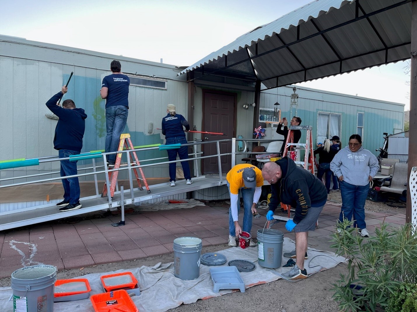 Volunteers from The Cigna Group work on a Habitat for Humanity build in Phoenix, AZ, making critical repairs on the home of a disabled veteran.