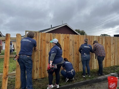 Volunteers from The Cigna Group install a fence with Veterans Community Project in St. Louis, MO.