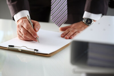 a man in suit filling out an application form