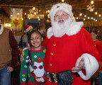 A young Guest takes a picture with Santa Claus during the annual Christmas Eve breakfast at Old Country Store Tuesday, Dec. 24, 2024.