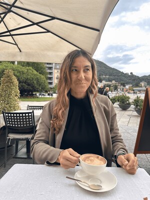 Shawna Lum enjoys a serene coffee moment by the shores of Lake Como, Italy. Since relocating to Spain in 2016 from California, she has guided thousands of Americans—retirees, remote workers, business owners, students, and sabbatical-seekers—in making their move to Europe.