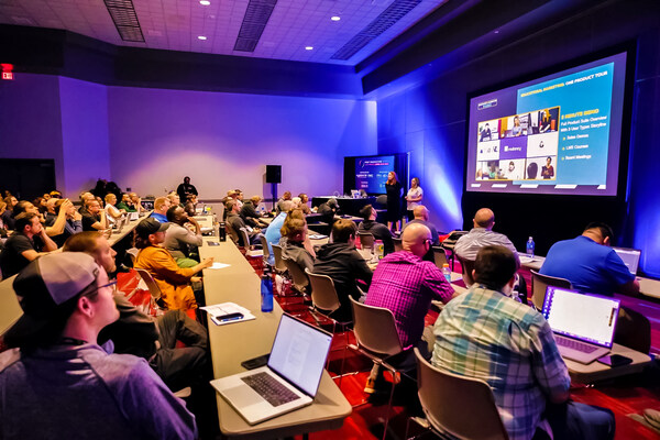 Attendees in conference hall participating in a workshop about post-production.