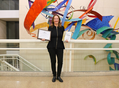 Tech Safety Lines CEO Diane Waghorne displays the awards after the company was the first-ever recipient of the Mayor’s Spotlight Award. (Courtesy Tech Safety Lines)