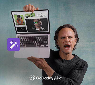 Walton Goggins holding laptop