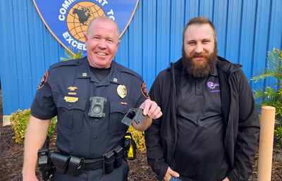 Lakeland Police Capt. Ron Bowling, Jr. (left) displays a firearm holster bracket designed and fabricated by Mike Kalman (right), mechanical engineering fabrication specialist at Florida Polytechnic University, and mechanical engineering graduate Matthew DeCicco ’24. The patent-pending design helps trigger an officer’s body camera when it detects that a firearm has been removed from its holster.