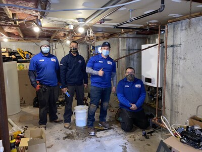 Picture of Al and team installing a free heating system for homeowner in need.