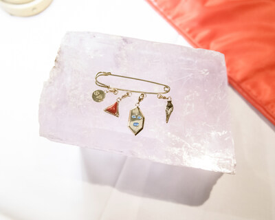 The safety pin attachment style from the Spanx x L'Enchanteur sculpted statement piece collection