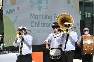 New Orleans themed second line celebrates the new Manning Family Children's logo.