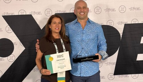 Liz Stewart, Co-Owner of Tinting K.C., accepting the award for XPEL's 2024 Paint Protection Film Dealer of the Year for Kansas. Award presented by Chris Hardy, Senior Director of Sales N.A.