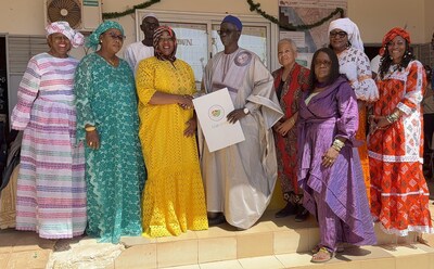 Forest Park Mayor Butler presents Yene Mayor Mbengue with a proclamation commemorating their Sister City relationship. Pictured (L-R): GA State Rep. Burnough; First Lady of Yene, Mrs. Mbengue; Forest Park Mayor Butler; Yene Mayor Mbengue; HBCU Green Fund founder, Felicia Davis; former Virgin Islands State Senator, Donna Gregory; Palmetto Mayor Thomas-Smith; Tandeka CEO, Letetia Daniels Jackson (front); and HBCU Green Fund Africa director, Cheikhou Thiome (back). Photo Credit: Kel (PRNewsfoto/HBCU Green Fund)