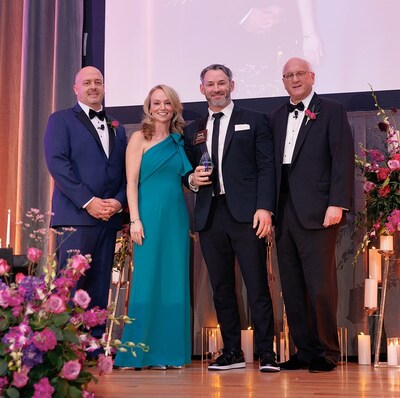 Doug Cormack, executive director of Orchard Estate of Woodbury, accepts the Benchmark Ripple Award on March 13, 2025