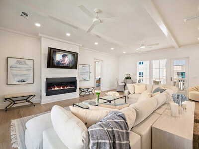 At 62 Woodward Drive, the grand salon includes a sleek, built-in fireplace and plenty of room to gather family and friends. The residence is ideal for entertaining or vacation getaways, and can accommodate up to 16 overnight guests. 30ALuxuryAuction.com.