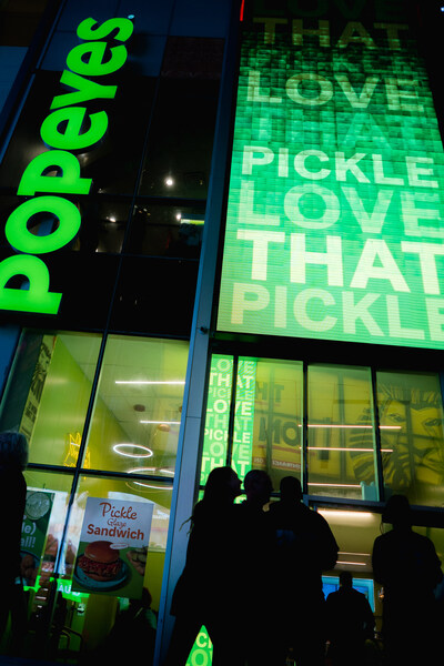 Popeyes turns iconic sign green at Times Square, New York restaurant to announce New Pickle Menu. Credit: Steven Irby for Popeyes.