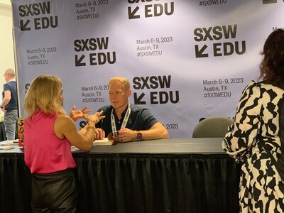 Boyer, co-founder of TEG, signs his latest book at an edtech conference
