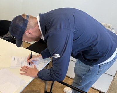 Liebherr deal being signed by Hunter Settlemier.