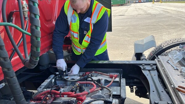 A Clarios technician installs the IdleLess battery monitoring system, helping fleets cut idling time by up to 60% and save thousands annually in fuel costs.