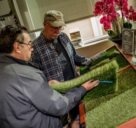 Two local Arizona landscape contractors looking at premium artificial turf samples in the North Phoenix showroom at The Synthetic Grass Store