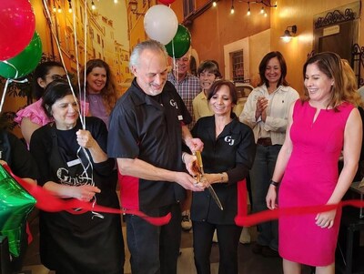 Owners Gina and Jeff Caro cut the ribbon at the May 7 grand opening of Gina's Gelato and Java in Parma Heights, Ohio.